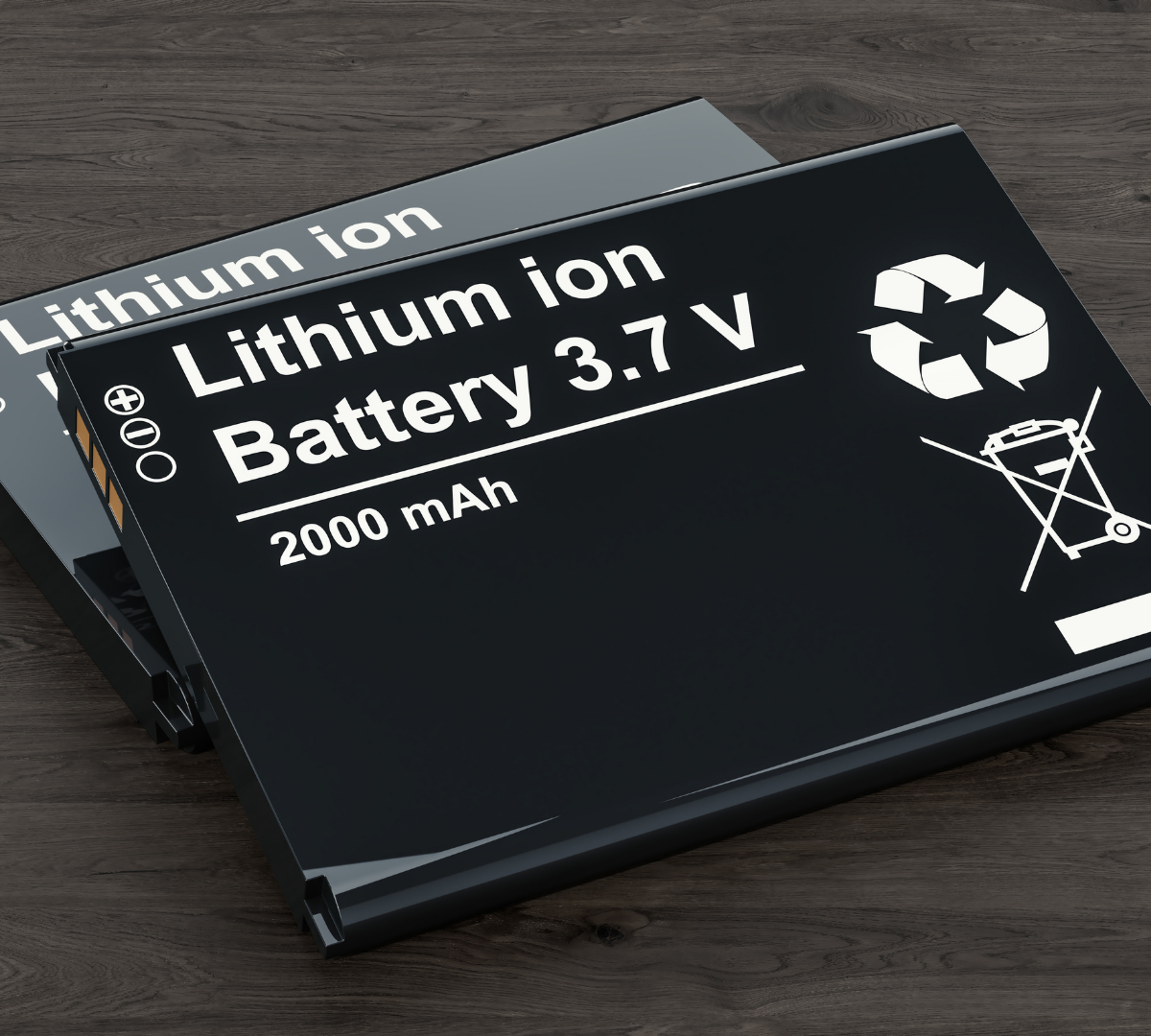 Two large rectangular flat lithium - ion batteries on a table