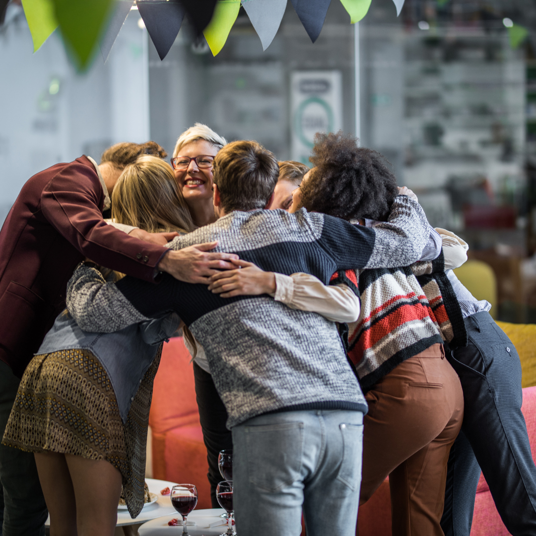 Group of people smiling in a huddle