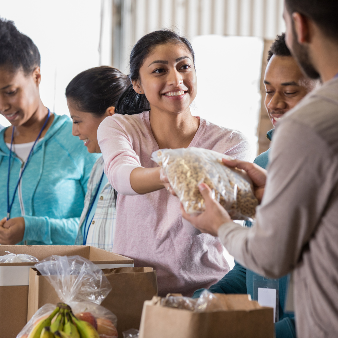 A person handing food to another person