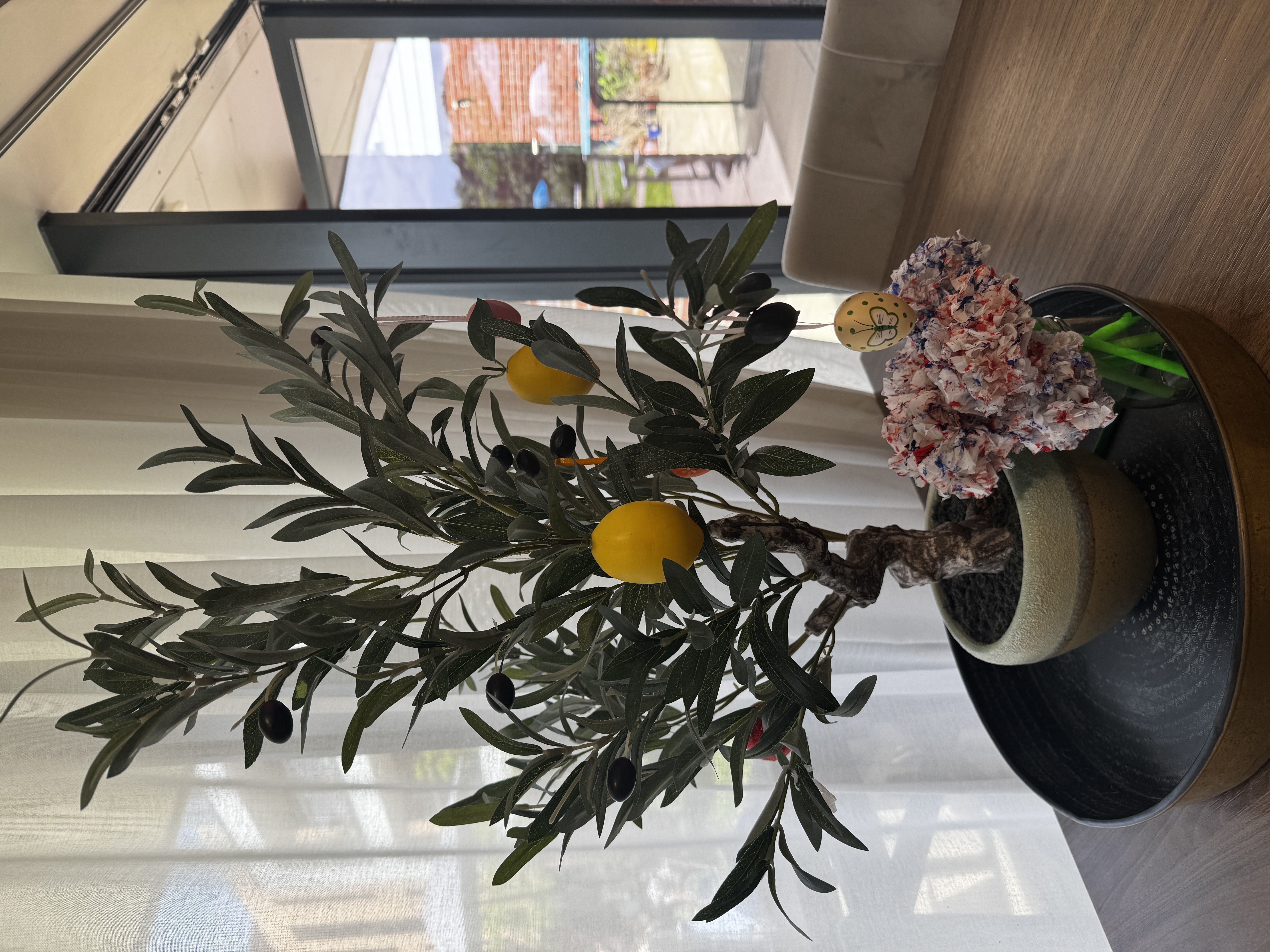 Lemon tree with red, white and blue floral decorations in front