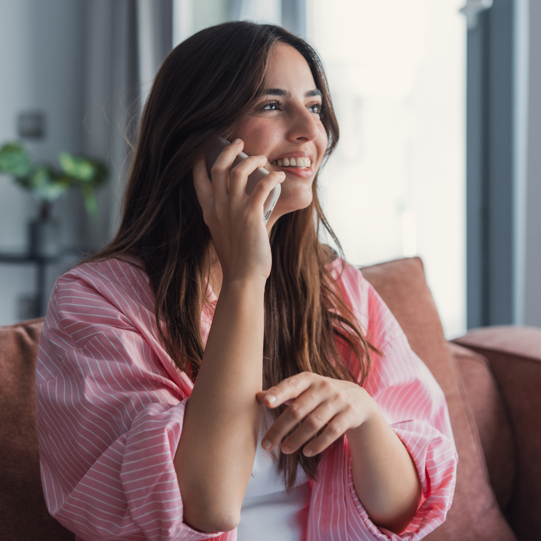 Lady smiling and holding phone