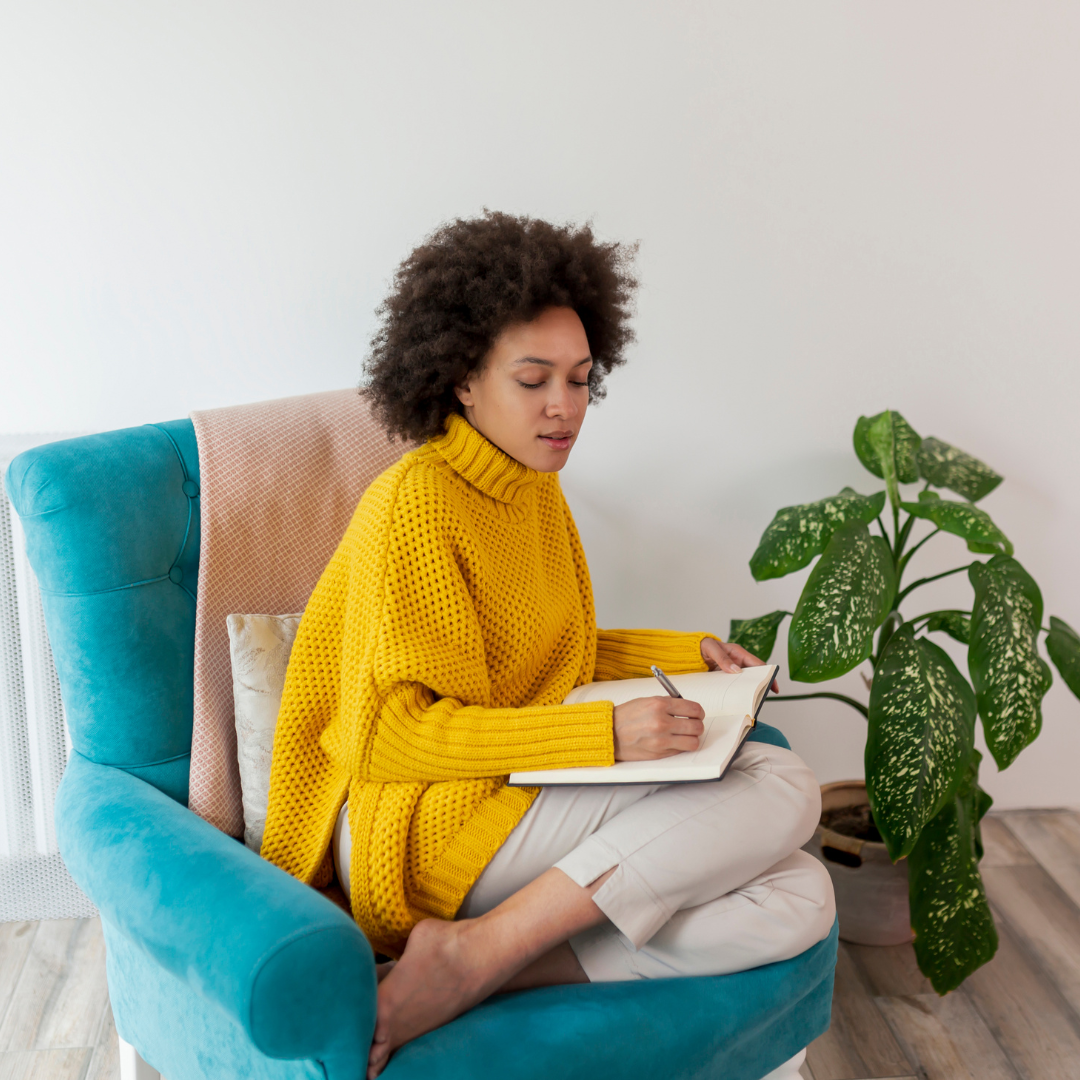 Person of chair writing in notepad