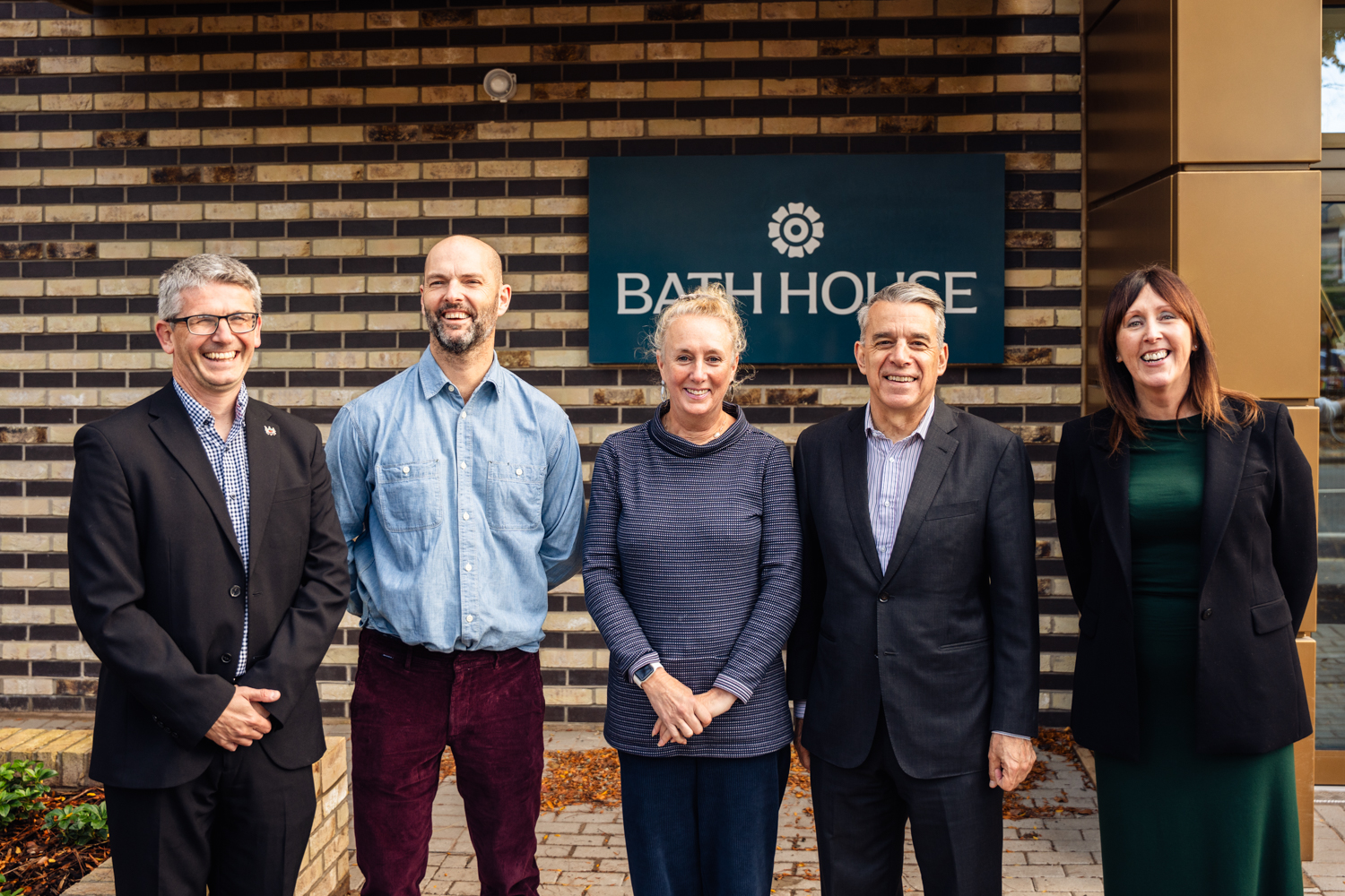Local Councillors, MP and CEO of MSV smiling in front of Bath House sign