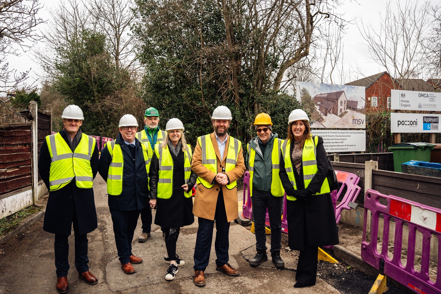 MSV staff and councillor pose for photo outside bredbury scheme 